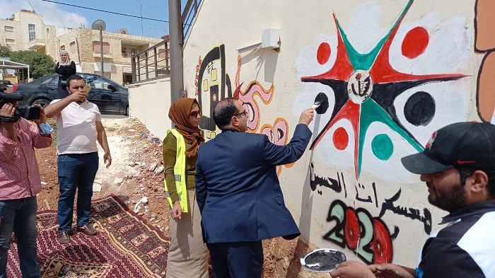 محافظ مادبا يفتتح جدارية السلام ضمن فعاليات معسكرات الحسين للعمل والبناء